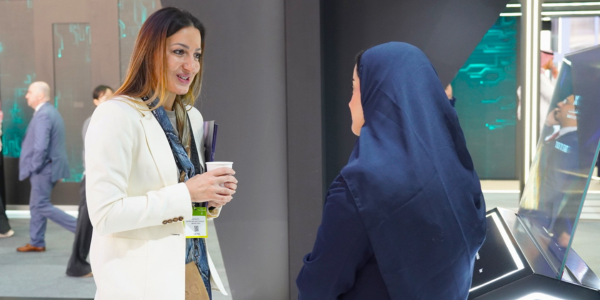 A woman smiling at someone speaking too her