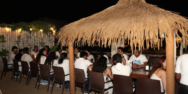 People sat at a table at night outside