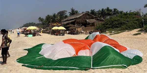 A parachute layed out on a beach