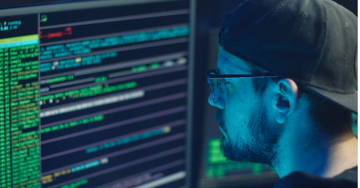 Man looking at code on a computer