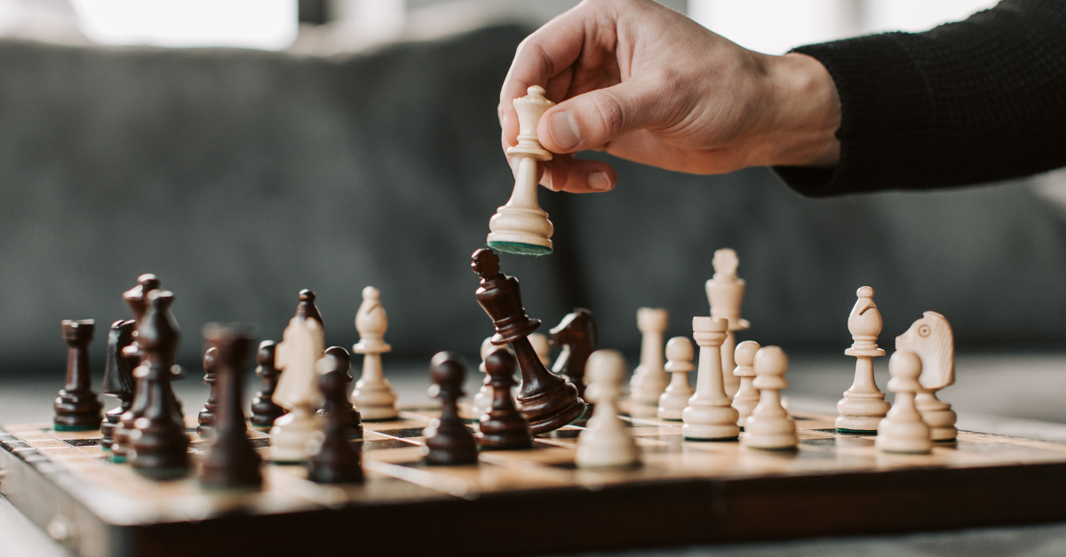 A hand moving chess pieces